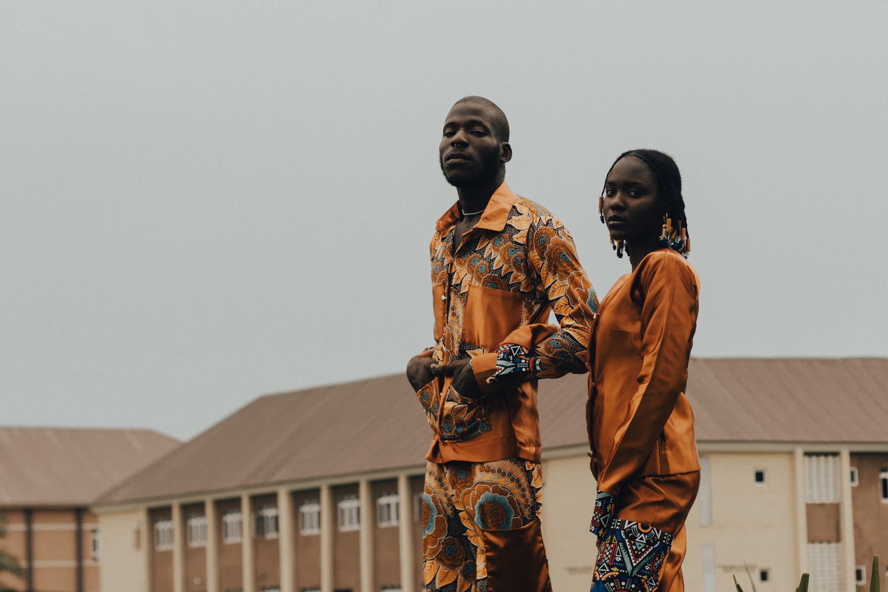 Man and Woman in Orange Printed Clothing Outdoors