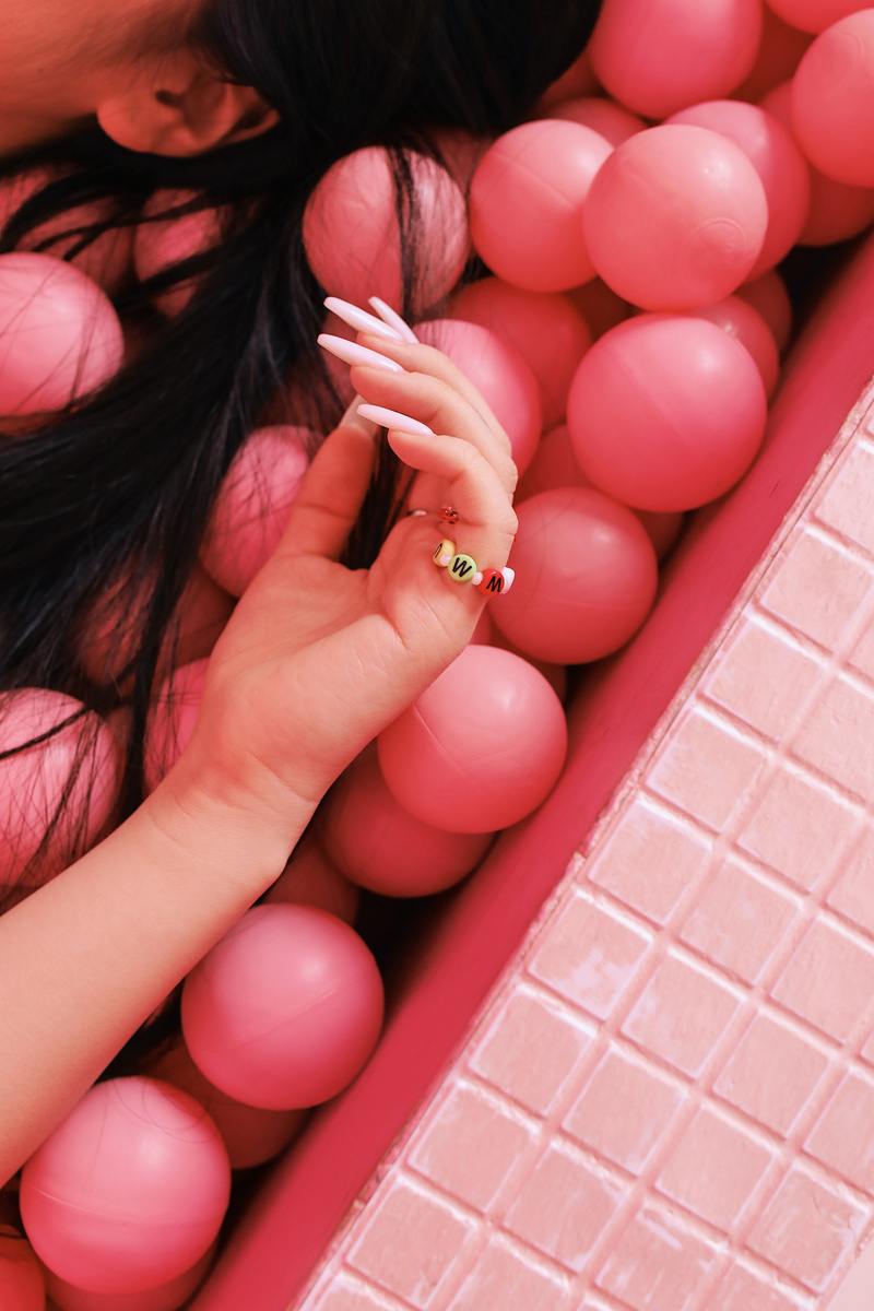 Woman Lying on Pink Balls