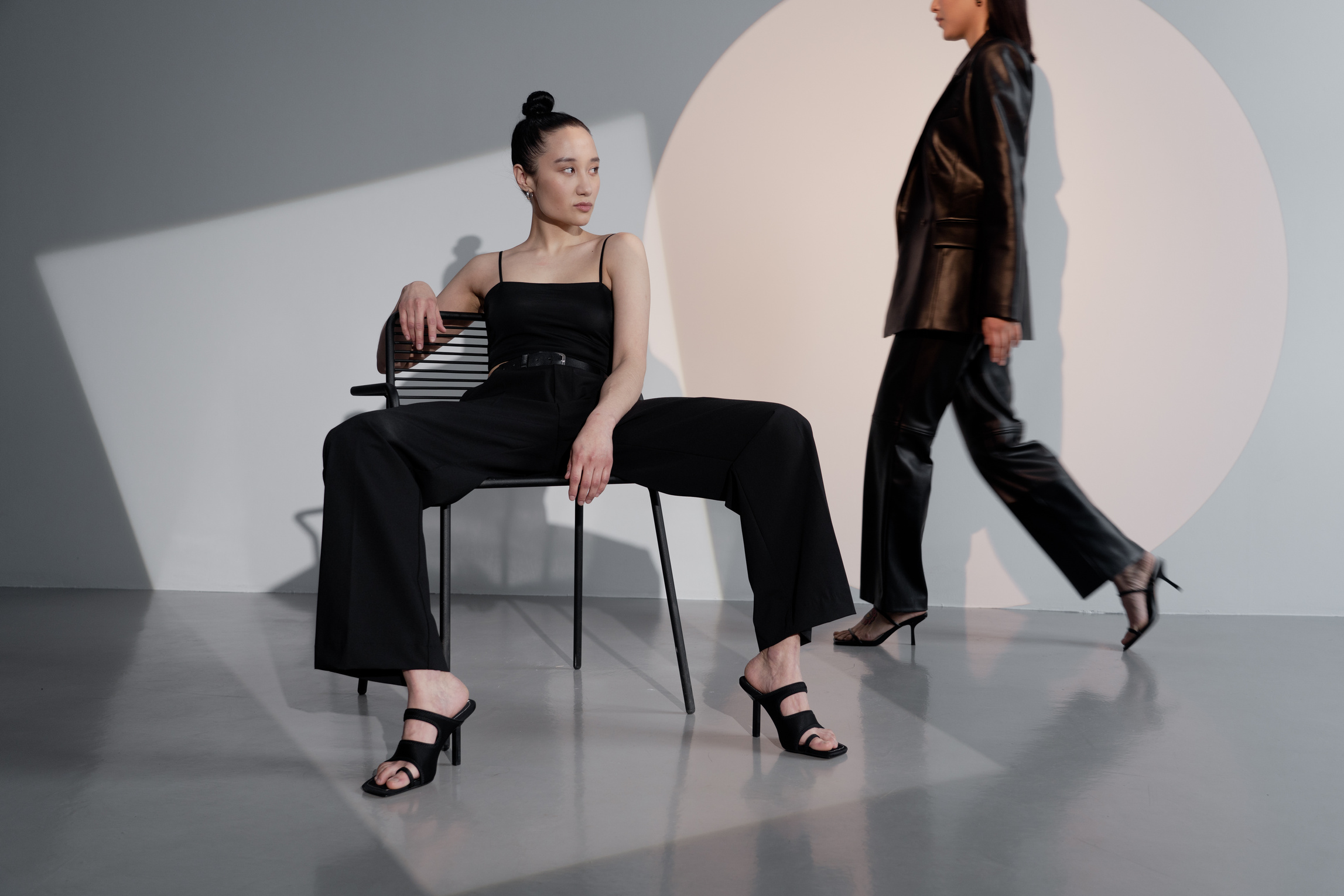Two Female Models in Black Outfits Posing 